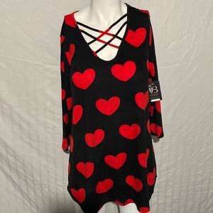 Half sleeve black shirt with red hearts.